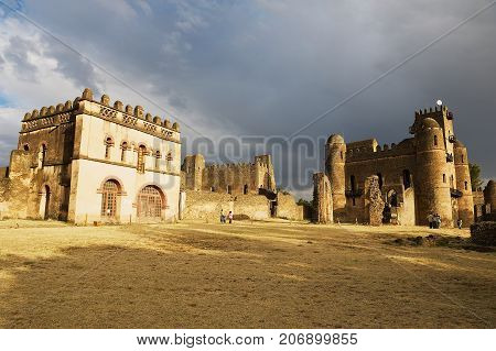 GONDAR, ETHIOPIA - JANUARY 22, 2010: Unidentified tourists explore medieval fortress in Gondar, Ethiopia. Gondar castle is a UNESCO World Heritage site.