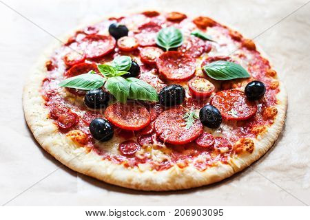 Pizza with cherry tomatoes and ham. Hot Original Italian Pepperoni pizza