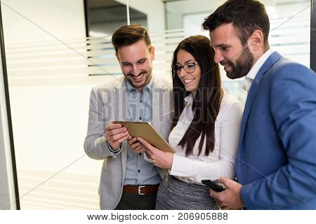 Businessmen and businesswoman using digital tablet in office