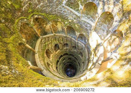 Background architecture. The Masonic Initiation well, the spiral staircase of Quinta da Regaleira in Sintra, Portugal.