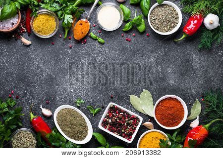 Set of Various spices and herbs on black stone table. Top view with copy space. Foood background.