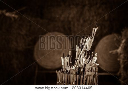Quiver of traditional feathered arrows in front of traditional ancient medieval straw practice archery targets, Medieval Mdina, Malta, April 2017