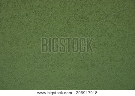 Green background from a fragment of a concrete wall of a building