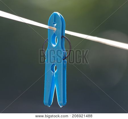 clothespin on a clothesline . In the park in nature