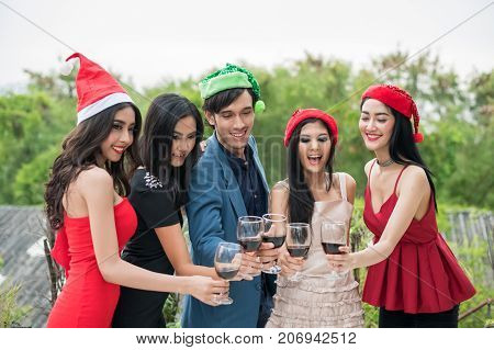 Young People Holding Glass Talk In The Party.