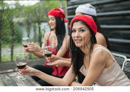 Young People Holding Glass Talk In The Party.
