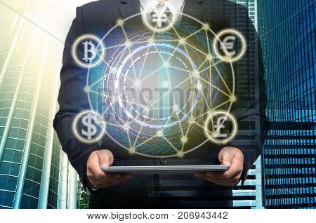 Businessman holding the laptop with Currencies sign symbol of Fintech technology over the Network connection of cityscape background Investment Financial Internet Technology Concept, 3D illustration