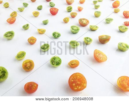 Colorful slices of tomatoes on white background