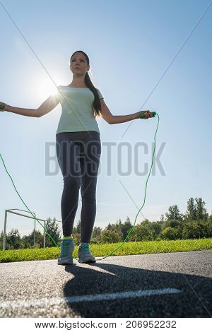 A Girl Is Jumping Rope On A Treadmill Of The Stadium