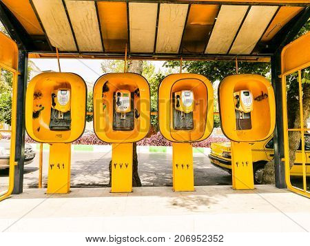 Four yellow telephone booths in a row
