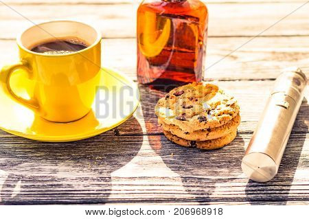Still Life With Electronic Cigarette With Botle And Coffe On The Wooden Background
