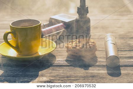 Still Life With Electronic Cigarette With Botle And Coffe On The Wooden Background