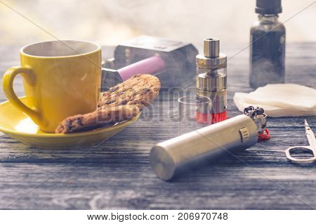 Still Life With Electronic Cigarette With Botle And Coffe On The Wooden Background