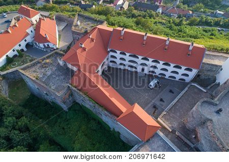 Beautiful panoramic view from the air to Palanok Castle at sunset and the city of Mukacheve