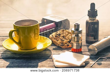 Still Life With Electronic Cigarette With Botle And Coffe On The Wooden Background