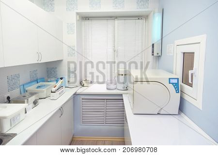 Modern sterilization room interrior, handling of dental instruments workplace