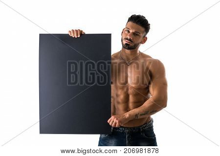 Naked young male bodybuilder holding blank black sign, isolated on white background, large copyspace