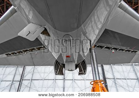 Auxiliary Power Plant In The Tail Of The Aircraft With Open Hood Covers, Jack Stand.