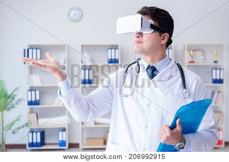 Young doctor with vr virtual reality headset working in the offi