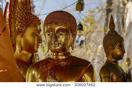 Three Golden Buddha Statues Together In A Tableau.