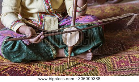 Closeup Of Woman Playing Thai Stringed Instrument.