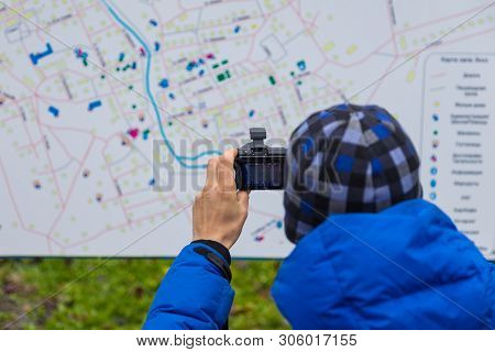 Esso, Kamchatka Peninsula, Russia: 02 October 2014: Tourist Taking A Picture Of The Esso Village Map