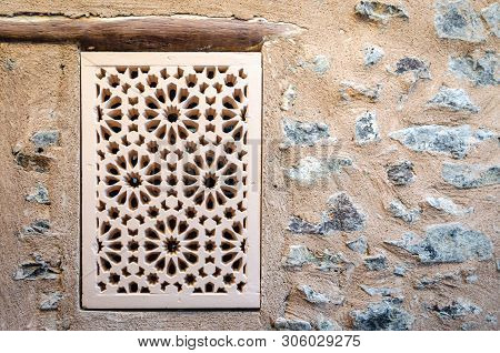 Old & Traditional Handicraft Pattern Window On A Stone Wall. From Muttrah Fort, Muscat, Oman.