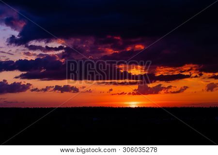 Evening Sky At Sunset Background. Dark Clouds Hanging Above Horizon. Majestic Cloudscape In Blue, Or