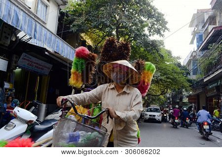Hanoi, Vietnam - September, 2015: Vietnamese Woman In Mask Walking With Bike And Selling Colorful Fe