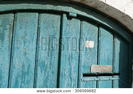 Old Wooden Door With Post Hole. Door With Blue Cracked Paint. Wood Texture.