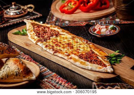 Traditional Turkish Cuisine. Turkish Pizza Pita With A Different Stuffing, Meat, Cheese, Slices Of V