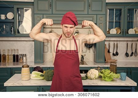 Sexy Muscular Chef In Front Of Kitchen. Attractive Chef Ready To Cook. Muscular Chef Posing In Kitch