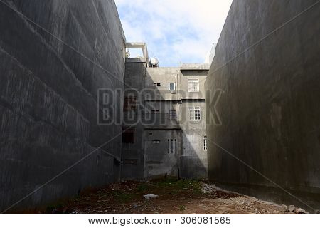 Empty Gap Between Two Houses With Grey Concrete Walls, Pleiku, Vietnam, September, 2015