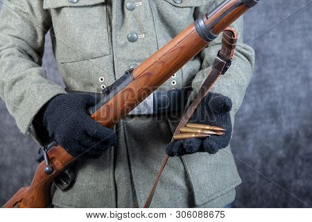 A Ww Ii German Soldier With Rifle And Ammunition