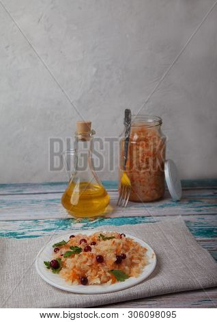 Fermented Cabbage Salad With Cranberries, A Bottle Of Vegetable Oil And A Cglass Jar Of Cabbage Stan