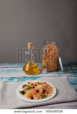 Fermented Cabbage Salad With Cranberries, A Bottle Of Vegetable Oil And A Cglass Jar Of Cabbage Stan