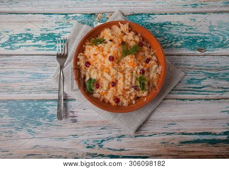 Fermented Cabbage Salad With Cranberries In Pottery And Fork Stand On A Wooden Blue Table On A Linen