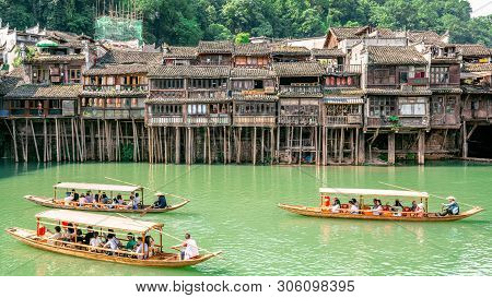2 June 2019, Fenghuang China : Traditional Wooden Boats Full Of Tourists Crusing On Tuojiang River A