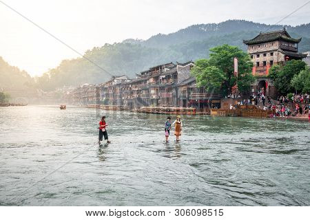 2 June 2019, Fenghuang China : Chinese Tourists On Stepping Stone Bridge And Old Houses In Early Mor