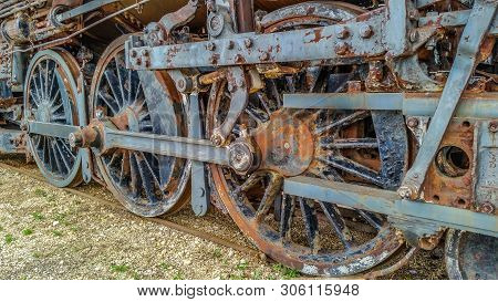 Rusty Wheels On A Old Steam Locomotive Sitting Abandoned In A Rail Yard Decaying Away