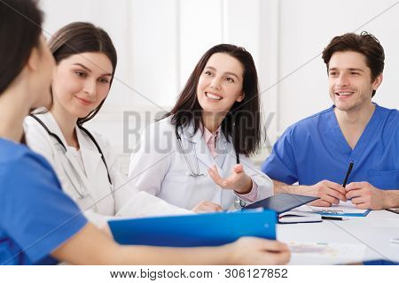 Medical Education. Interns With Mentor Meeting And Taking Notes At Hospital
