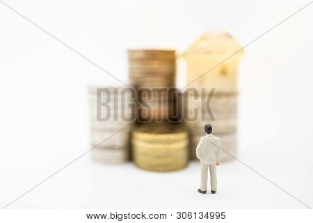 Business Saving, Home Loan Concept. Close Up Of Businessman Miniature Figure Stnding And Looking To 