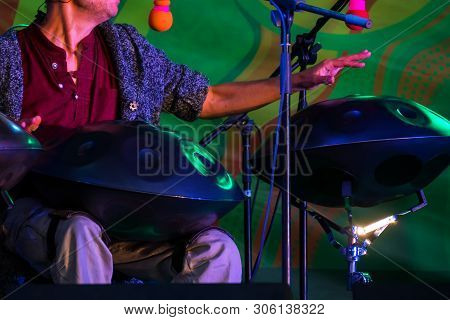 Man Playing Tank Drum Or Hang On Stage Of Ethnic Open Air Concert. Relaxation, Folk, Meditative And 