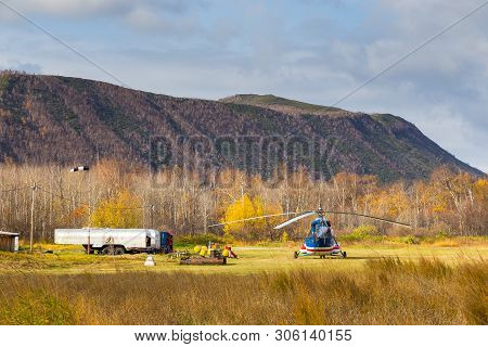 Anavgay, Kamchatka Peninsula, Russia- 03 October 2014: Helicopter Parked At A Small Airport. Mountai