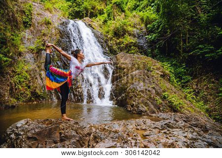 Asian Women Relax In The Holiday. Play If Yoga.  Play If Yoga At Waterfall On The Moutain. Exercise,