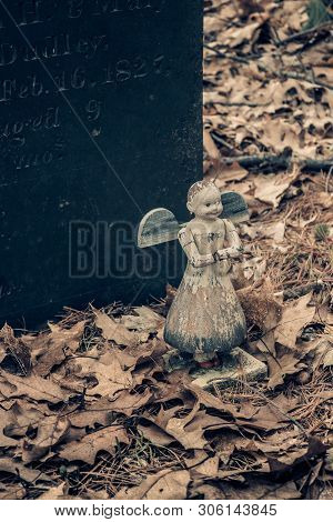 Old Angel Toy On A Child's Grave