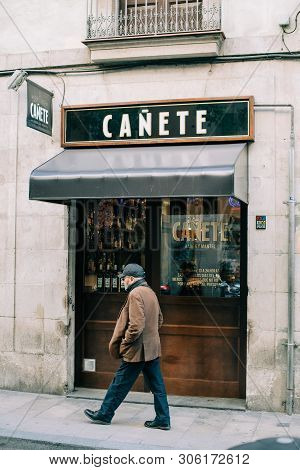 Barcelona, Spain - Nov 14, 2017: Senior Man Walking Alone In Front Of Canete Bar Pub In Central Barc