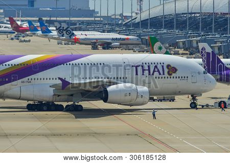 Passenger Airplanes Taxiing On Runway