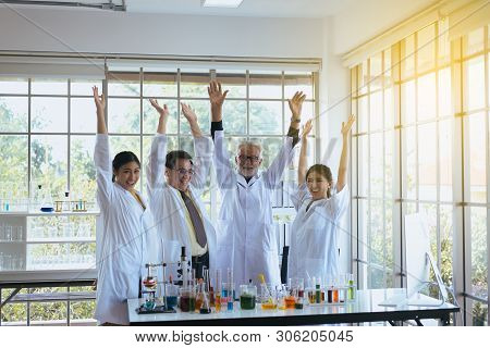 Scientists Hands Rais Up Together,group Of Diversity People Teamwork In Laboratory,success And Reser