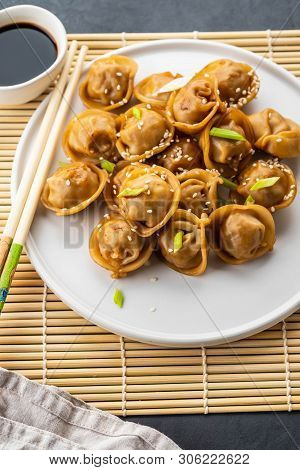 Home Made Chinese And Korean Dumplings Served On The Traditional Steamer And Bamboo Mat Decorated Wi